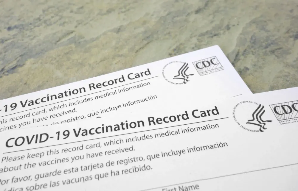 Two COVID-19 vaccination cards